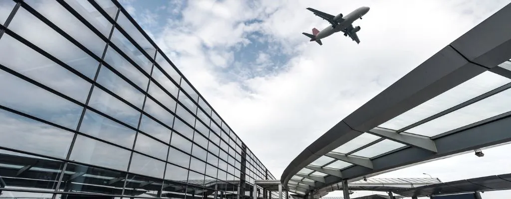 Airport Building with an airplane flying over