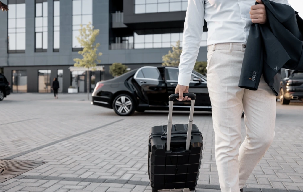 business man arriving at destination after his airport limousine service