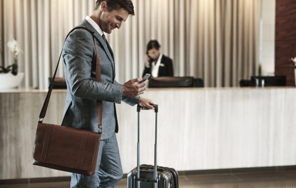 Businessman arriving in hotel after his limousine airport service drop off